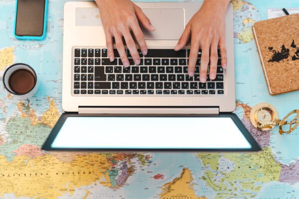 Planning your itinerary - tips and tricks top view female hands using laptop on world map bo 2021 09 03 20 12 15 utc 600x400 - Planning a travel route - tips and tricks