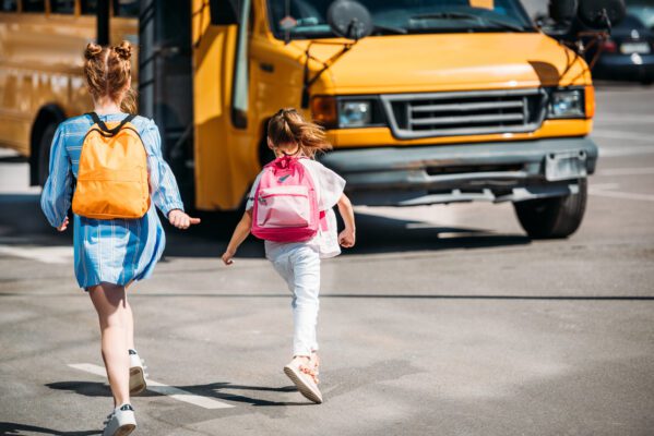 Why GPS trackers for school bags are so important rear view of schoolgirls with backpacks running to 2022 12 16 21 05 24 utc 599x400 - Why GPS trackers for school bags are so important